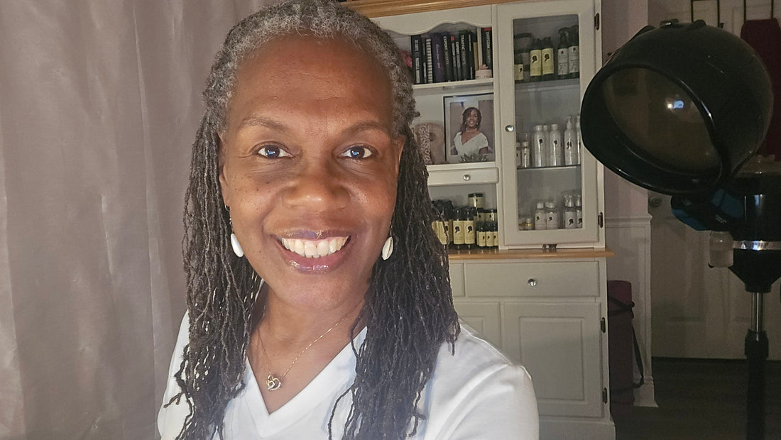 Confident Black woman with Sisterlocks — representing beauty, community, and feminine strength