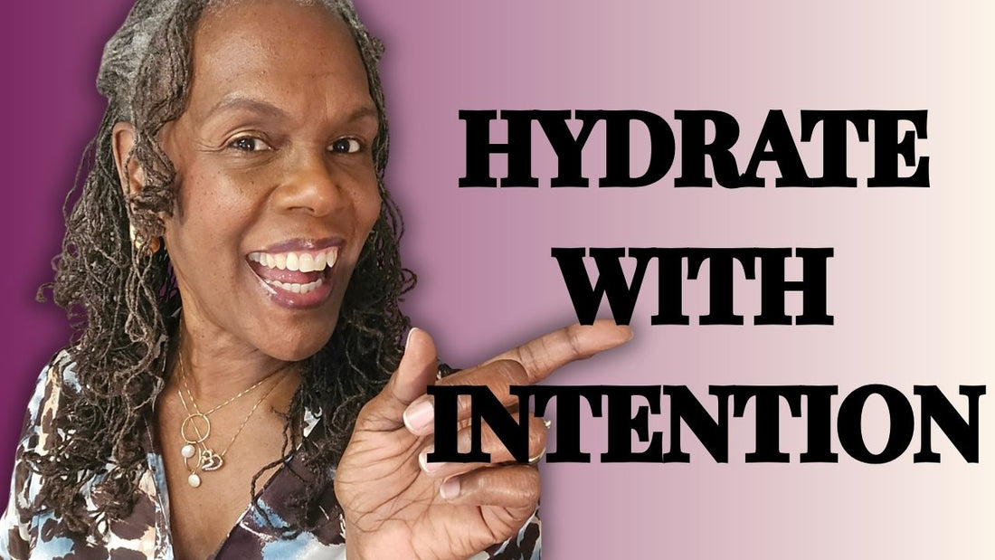 Rene’ Michelle Floyd pointing to the thumbnail title “Hydrate With Intention” on a purple background, teaching a weekly hydration ritual for medium porosity Sisterlocks.