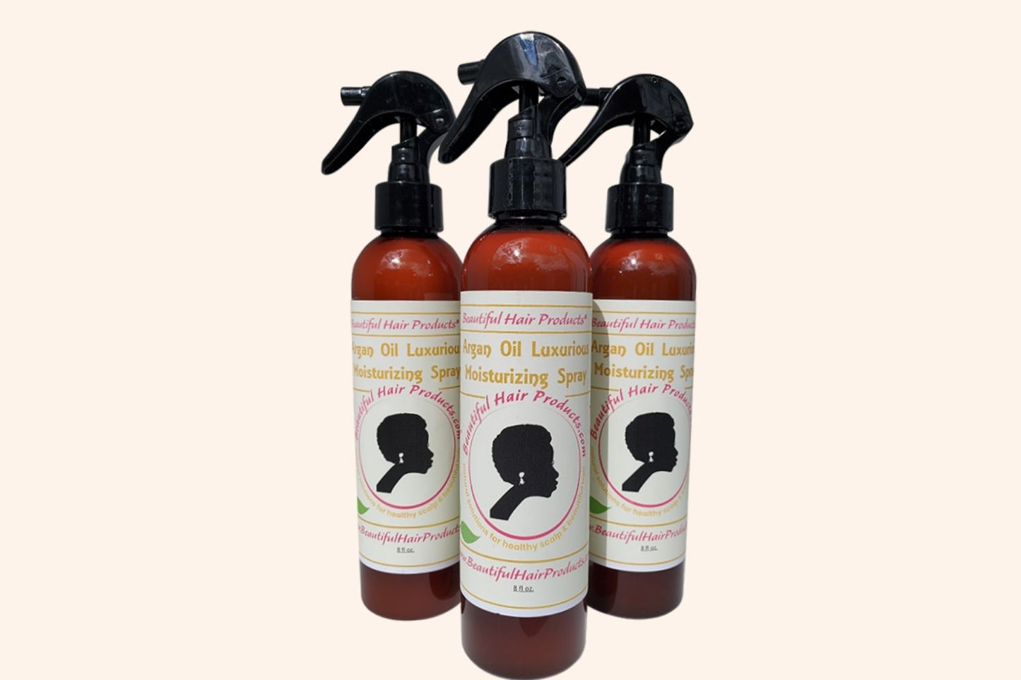 Three bottles of Argan Shine Revival Leave-In Mist bottle, 8oz with gold and cream label featuring argan for medium porosity shine enhancements 