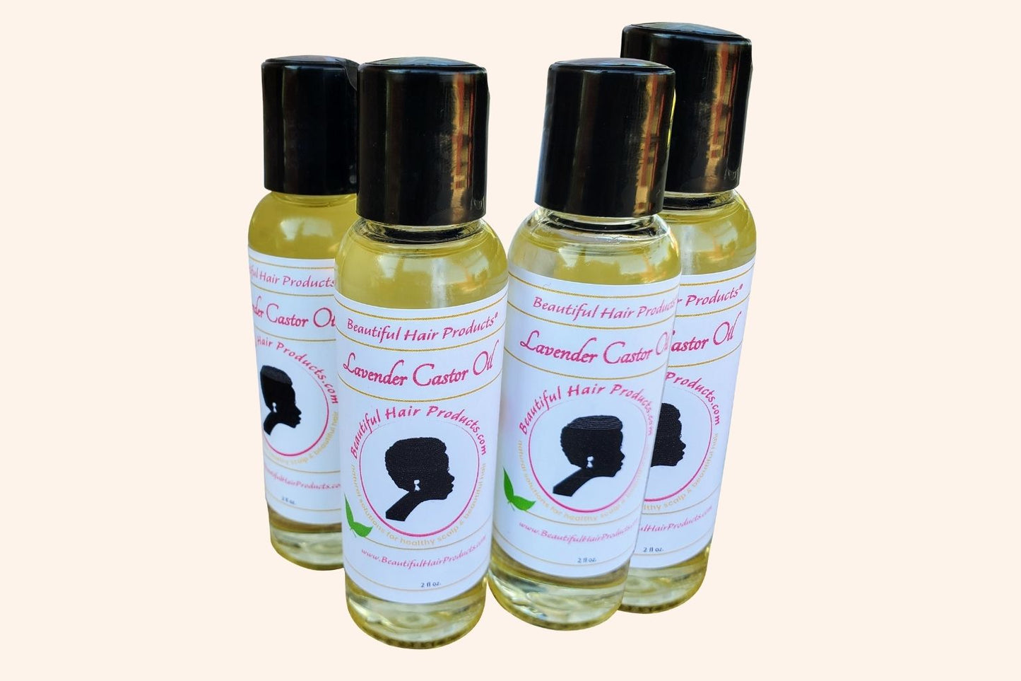Four bottles of Lavender & Castor Scalp Therapy Oil bottle with purple and cream label for therapeutic scalp treatment