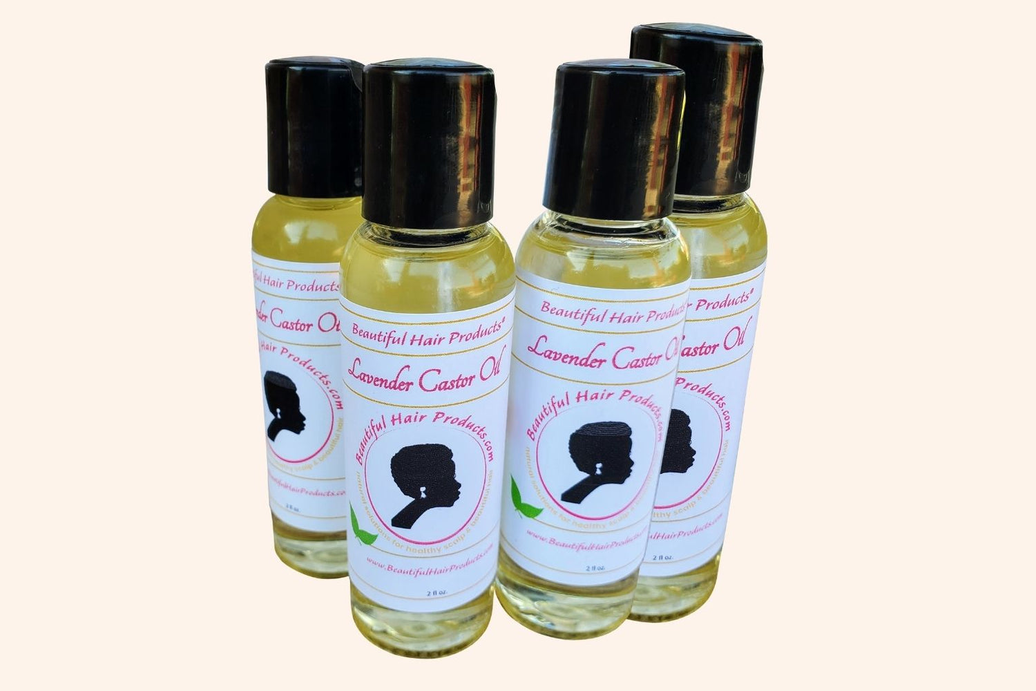 Four bottles of Lavender & Castor Scalp Therapy Oil bottle with purple and cream label for therapeutic scalp treatment