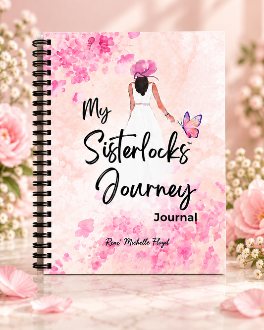 My Sisterlocks Journey Journal spiral-bound cover displayed upright in a soft pink floral setting.